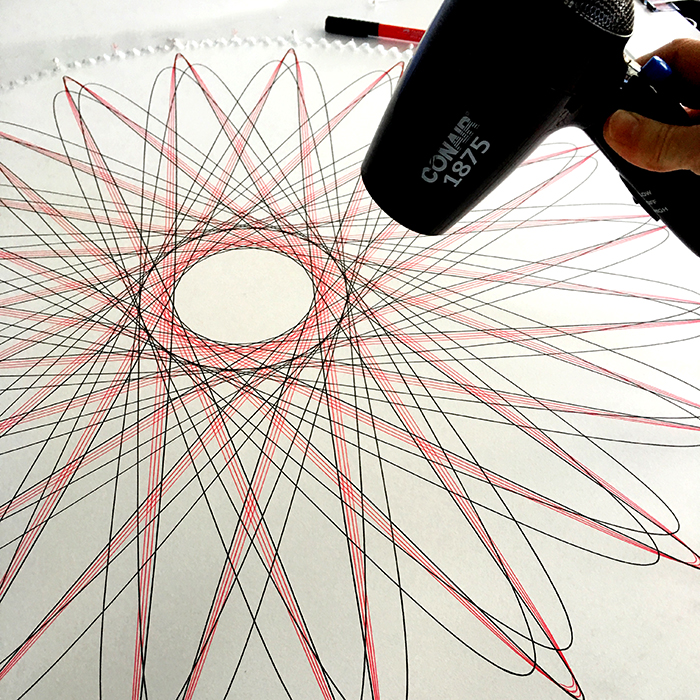 Drying ink with blow-dryer.